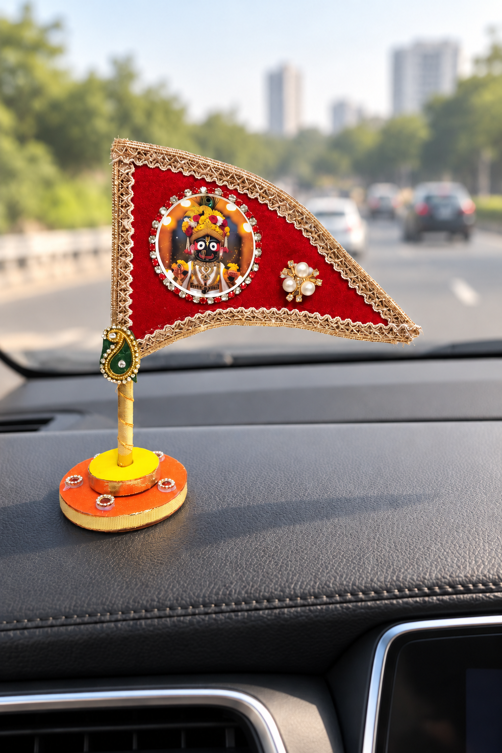 Jagannath Ji red nishan displayed on car dashboard