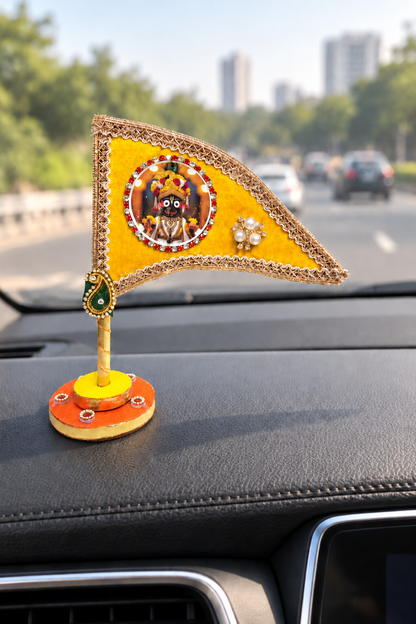 Jagannath Ji yellow nishan displayed on car dashboard